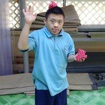 Wave from young man from Eden Centre for Disabled Children