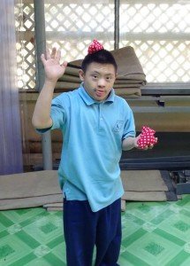 Wave from young man from Eden Centre for Disabled Children